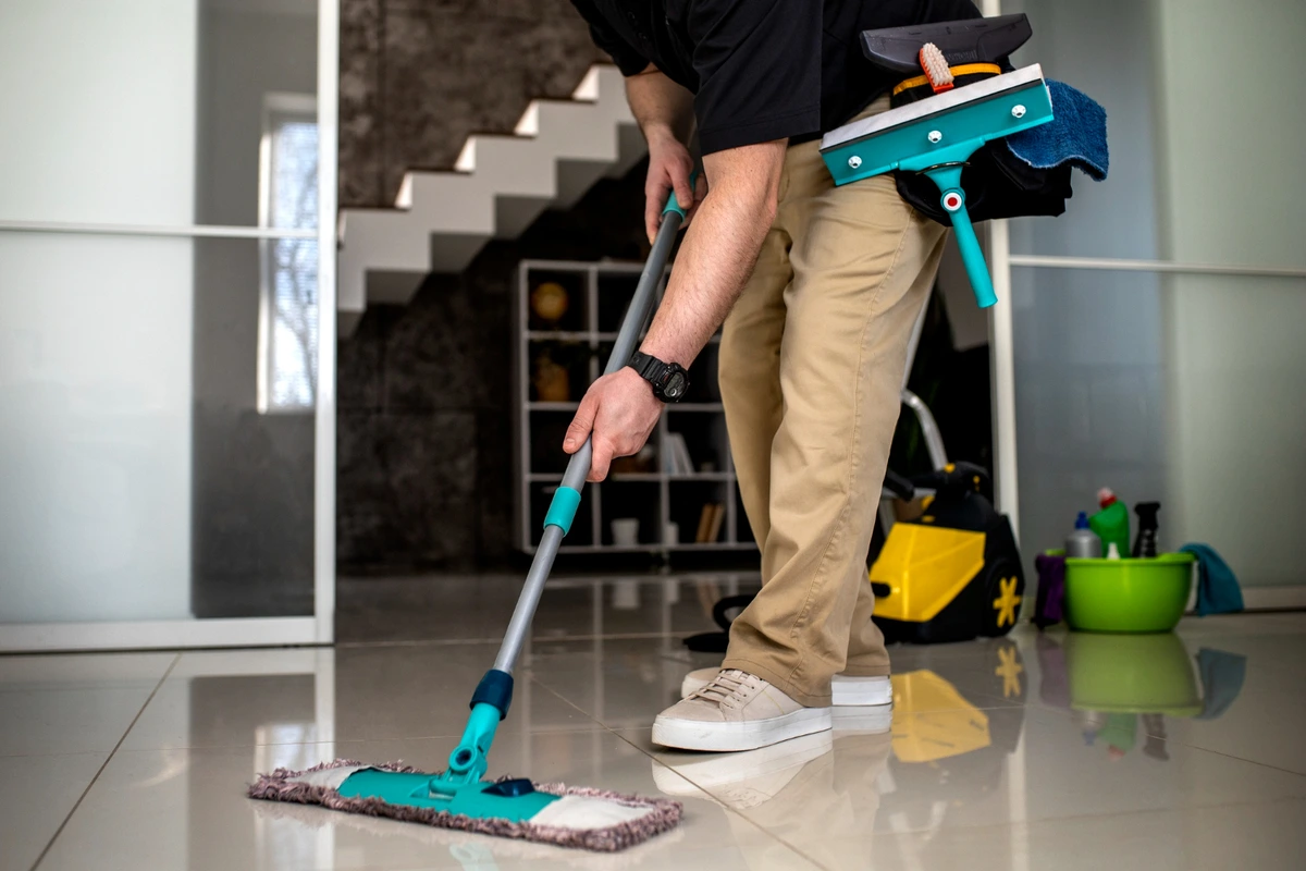 Cleaner mopping a floor.